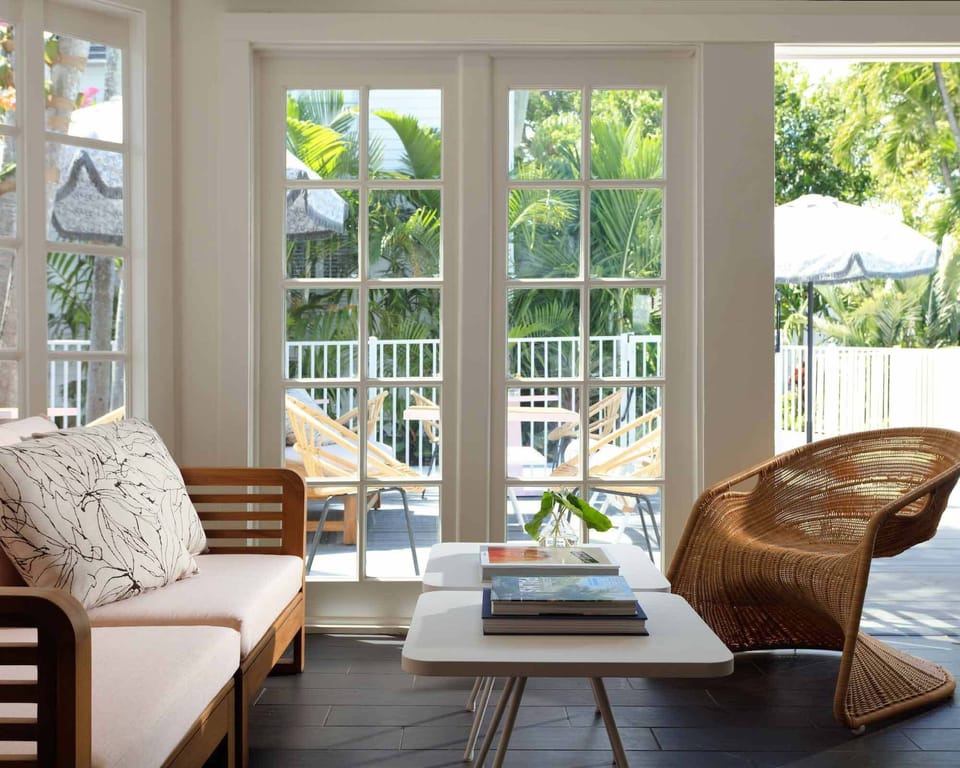 Relax indoors with airy seating and leafy pool views.