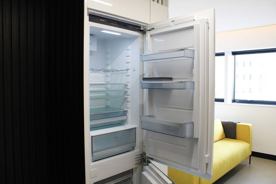 The refrigerator and freezer are full-size, allowing for ample storage of food items. 