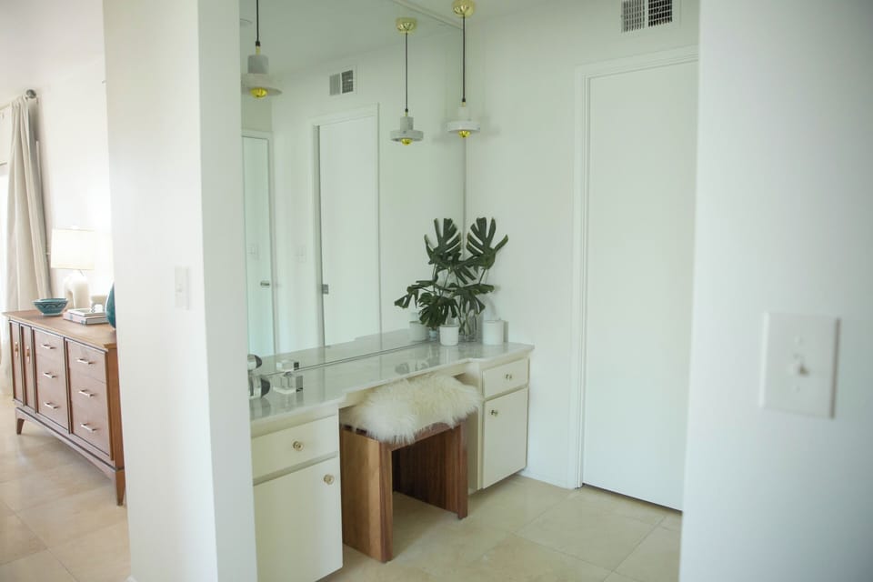 Private ensuite vanity, dressing area., and walk-in closet.