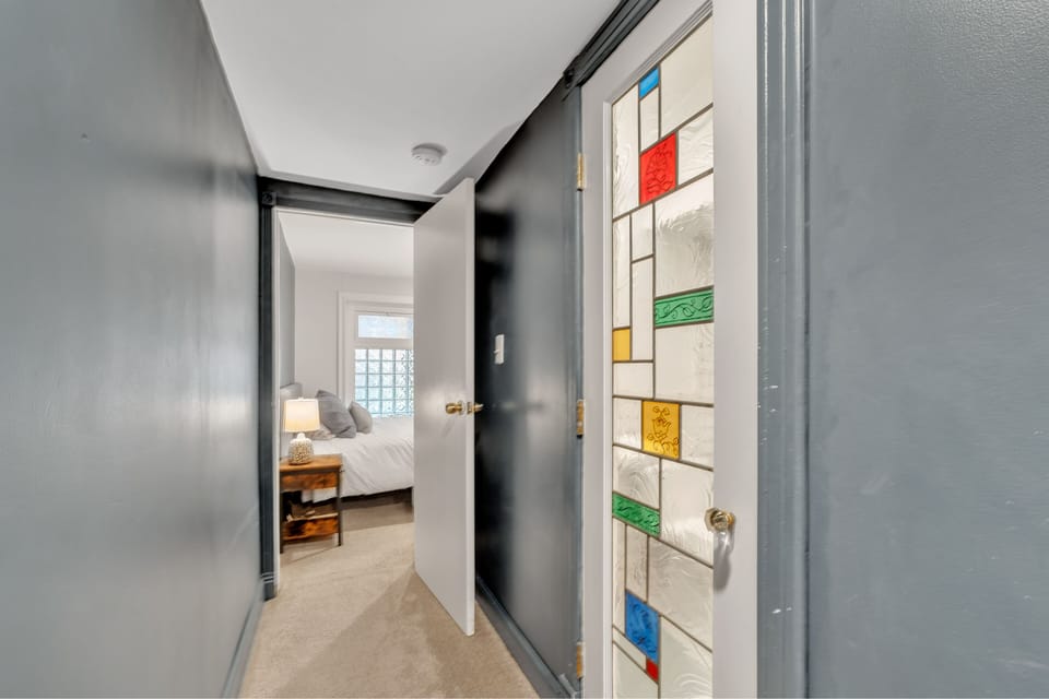 hallway looking toward bedroom, with beautiful bathroom door