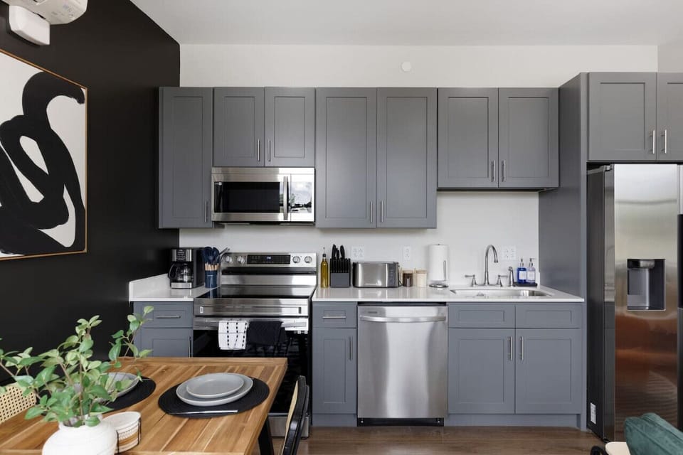 Cook with ease in this well-equipped kitchen featuring stainless steel appliances, ample cabinetry, and a stylish backsplash. Whether you`re brewing coffee or preparing a gourmet meal, this space is designed for functionality and style, making every meal