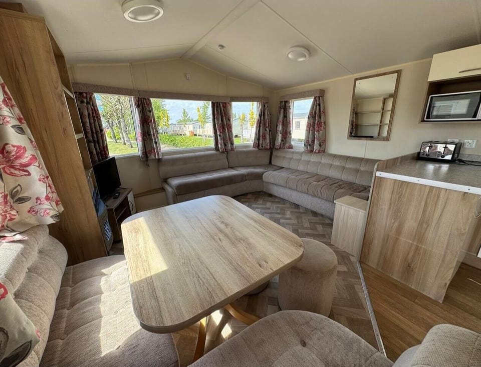 The caravan living area is perfect for quality time, board games, or simply putting your feet up with a cup of tea while recounting the day's adventures.