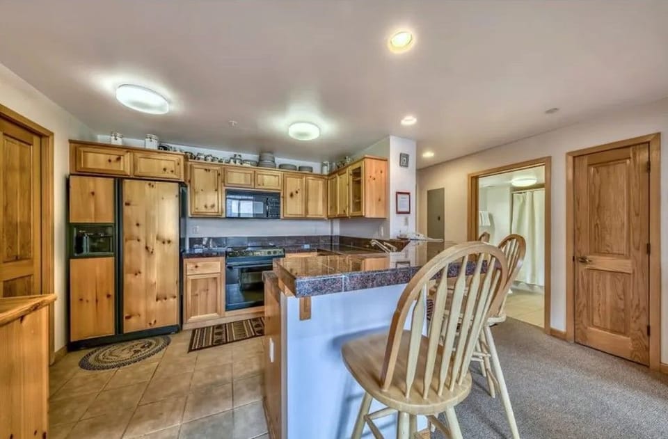 Cook up a storm in this inviting kitchen, featuring warm wooden cabinetry and ample space for culinary creations.