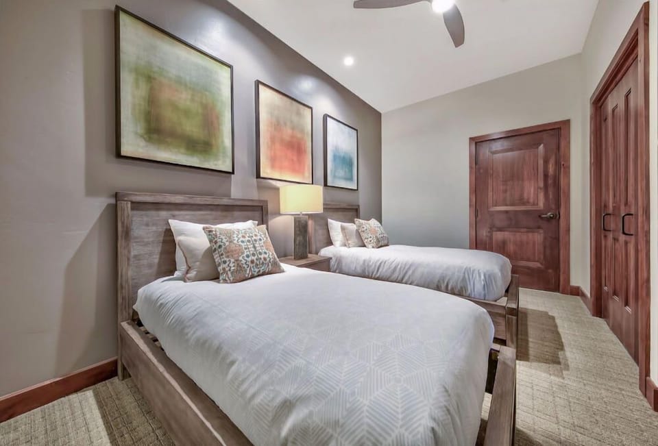 Guests will love this cozy bedroom, equipped with a comfortable bed, soft linens, and calming artwork for a restful stay.