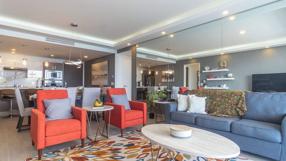 Large wall sized mirror above sofa