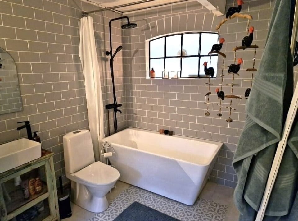 Bathroom on the main level behind the kitchen area.