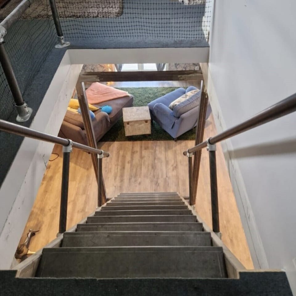The custom designed staircase i slightly steeper than standard, with hand rails.