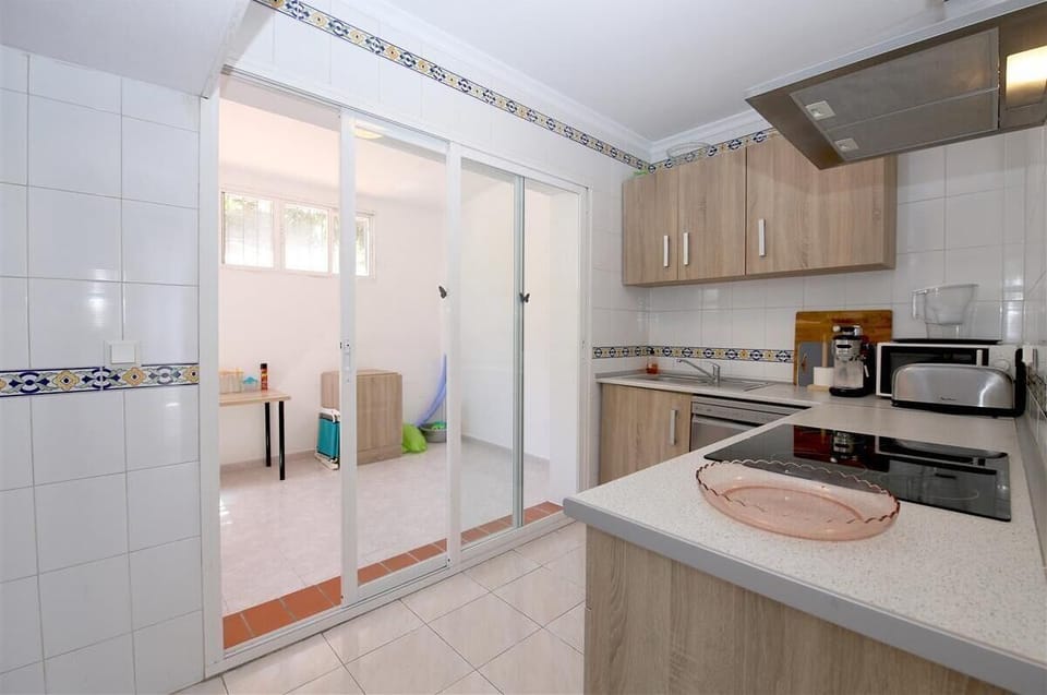 Modern kitchen with all the appliances and laundry room to the rear