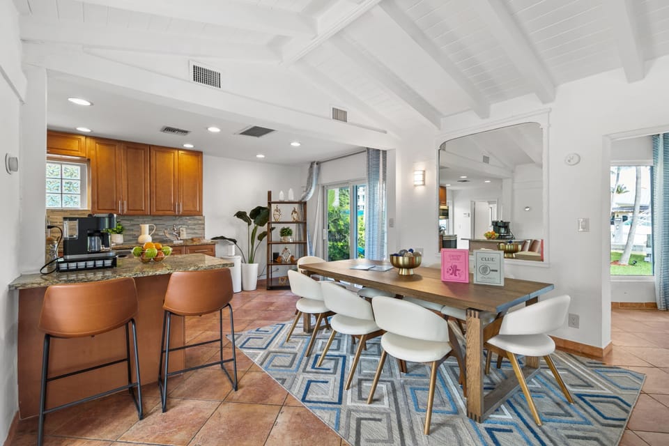 The open floor plan seamlessly connects the kitchen and dining area, which comfortably seats 8