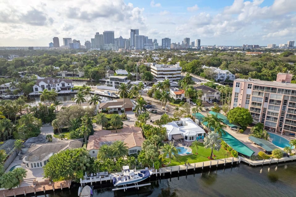 Soar above our serene canal-front retreat with this stunning aerial view, showcasing the tranquil waterfront setting and expansive layout