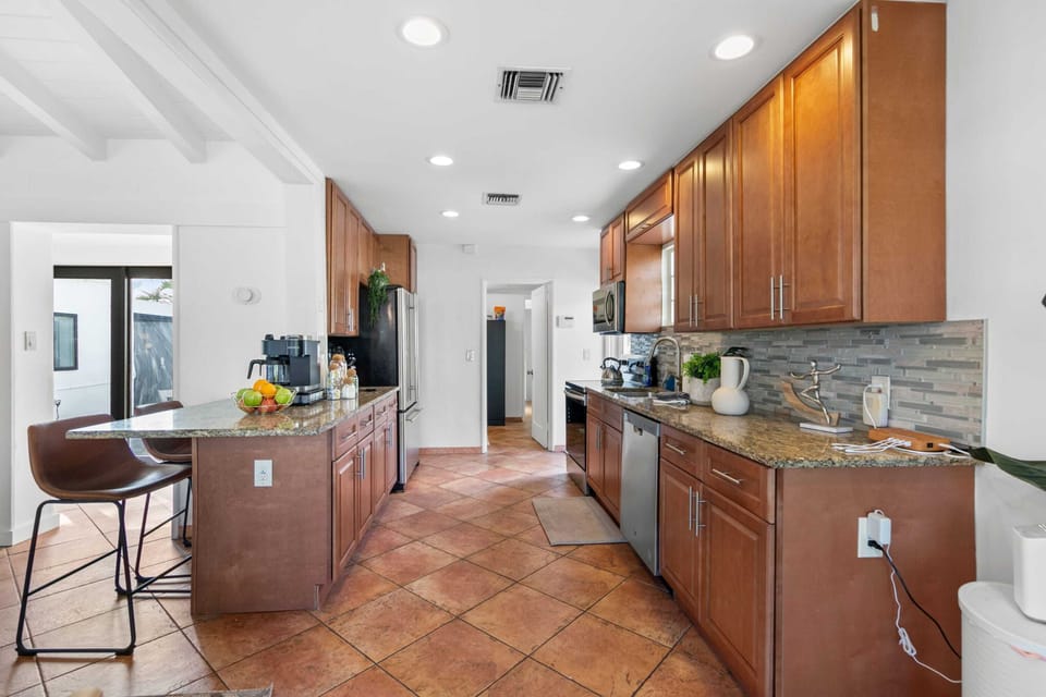 Offering ample cabinetry and a large island with bar stools
