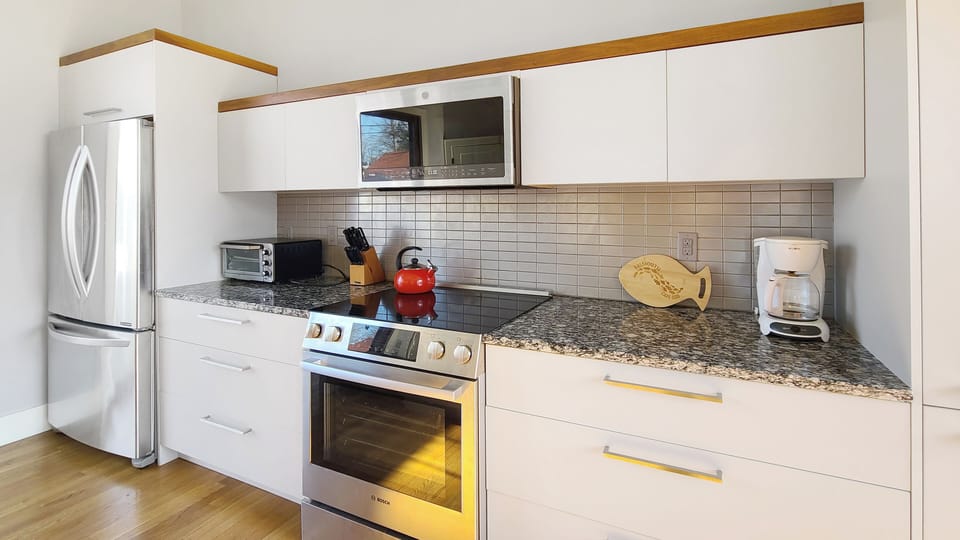Kitchen has stainless appliances and granite counter tops