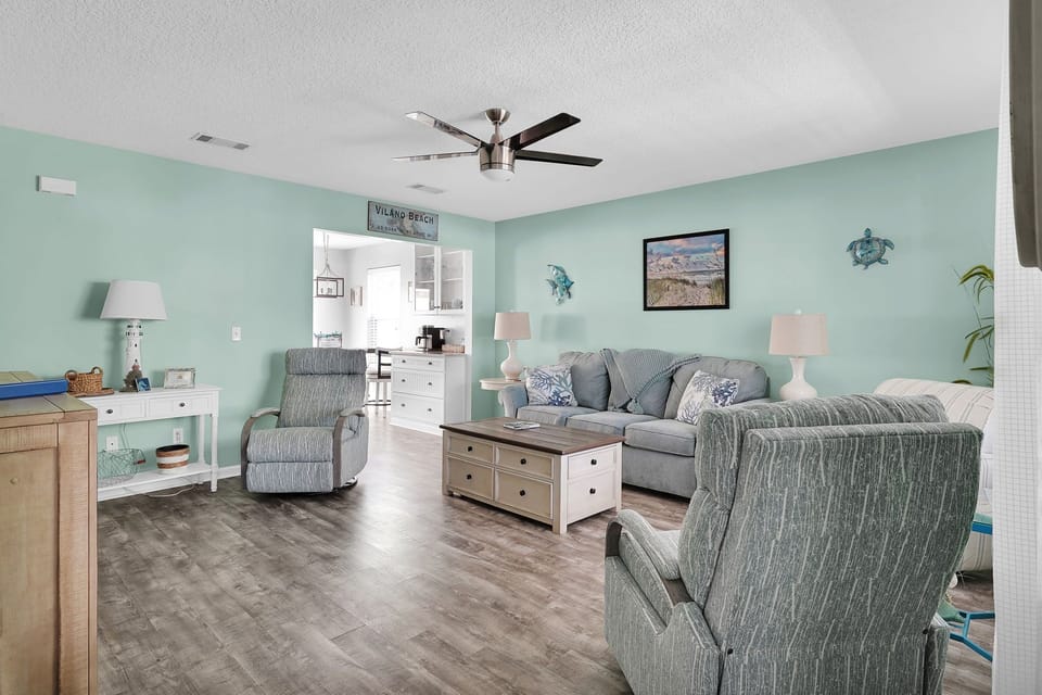 Large living room space with comfortable seating and smart TV
