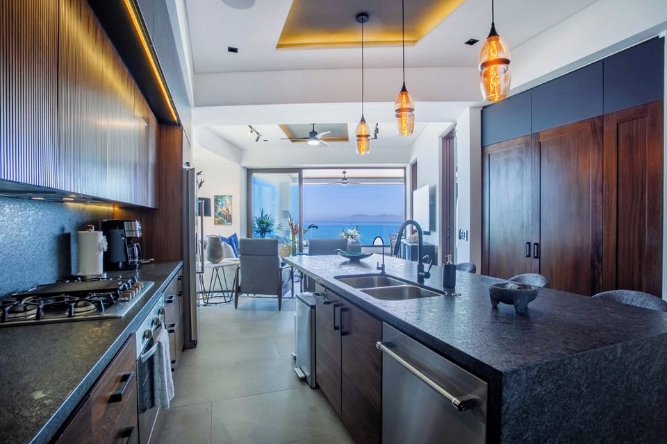 The modern kitchen boasts a stylish bar, comfortably accommodating seating for four