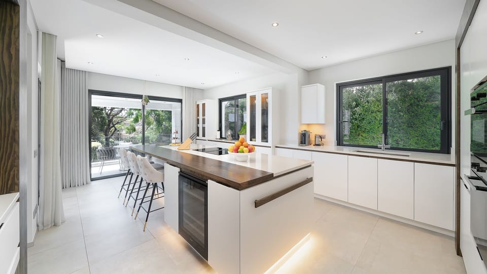 This sleek, fully-equipped kitchen blends modern design with natural light, perfect for creating gourmet meals or enjoying a casual breakfast. 

#Algarve #Portugal #ModernLiving #GourmetKitchen #LuxuryHome