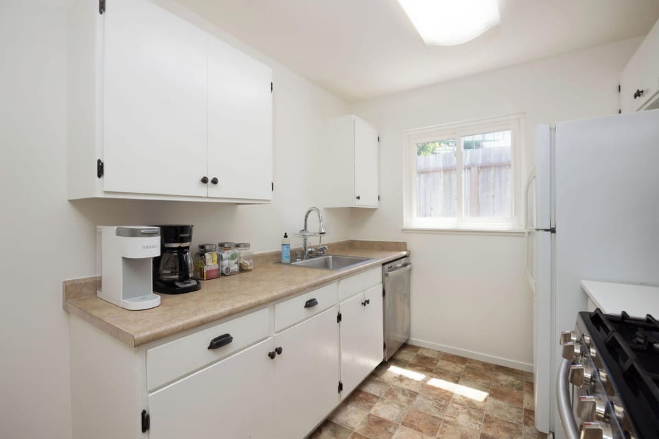 Sleek kitchen corner with sink, coffee maker, and organized drawers