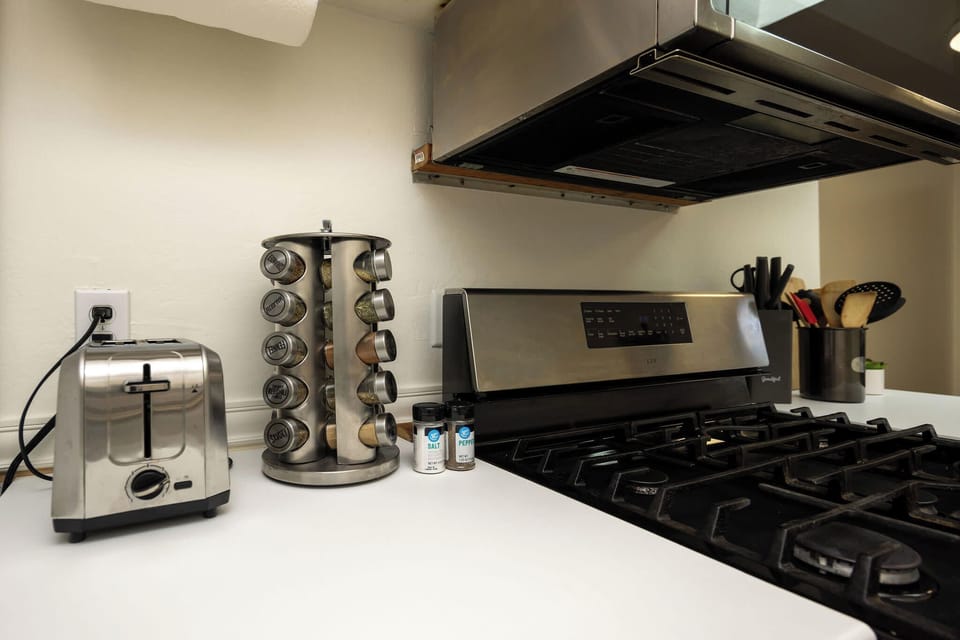 Fully equipped kitchen featuring stove, oven, fridge, and toaster