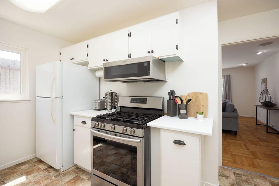 Fully equipped kitchen featuring stove, oven, fridge, and toaster