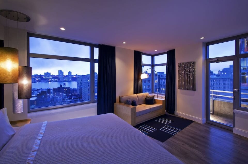 Wake up to sweeping skyline views from this serene bedroom.