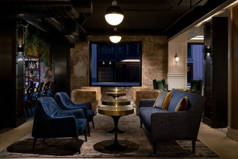 Kick back on velvet seating with softly lit evening vibes.