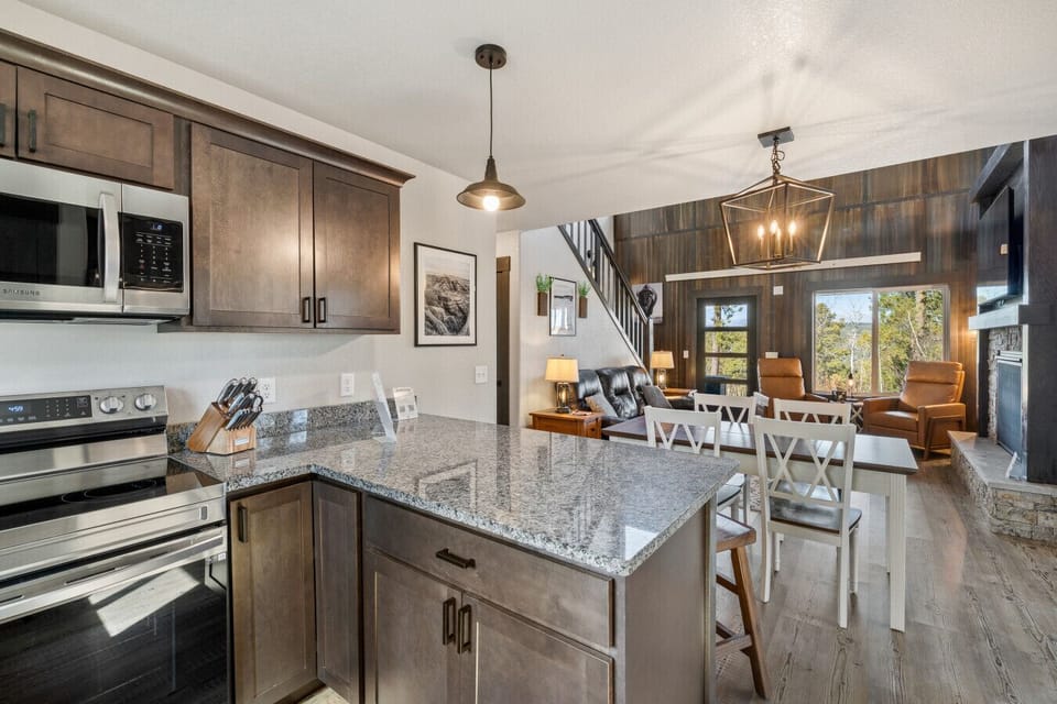 An open and inviting space where the kitchen, dining area, and living room come together, creating a warm and comfortable place to cook, dine, and relax.