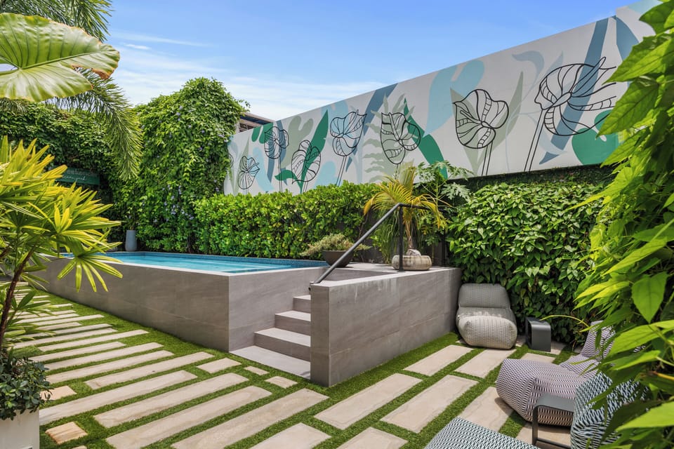 Escape the hustle and bustle in our secluded pool area, complete with lush tropical plants and comfortable loungers.