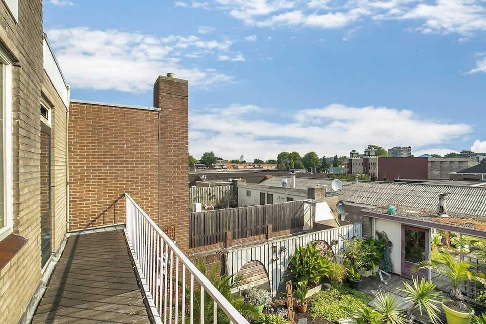 Balcony with city views and a garden below for relaxing outdoor moments.