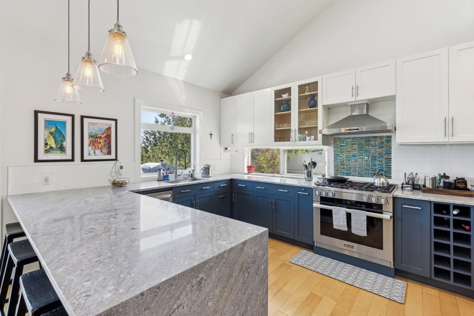 Large kitchen with quartz countertops and professional grade range.