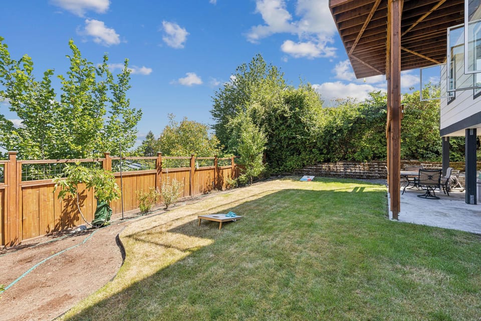 Large partcially fenced backyard great for outdoor games like Cornhole. Perfect for your dog too!