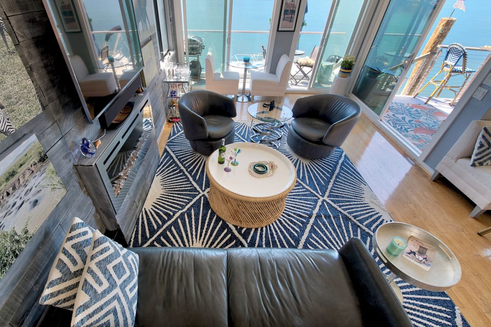 Looking down to the Living room with walls of glass facing the bay