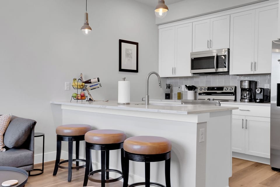Barstools for in-kitchen dining and fully stocked kitchen.