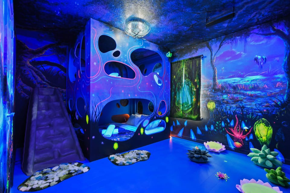 Enchanting glow-in-the-dark bunk room with slide and fantasy art!