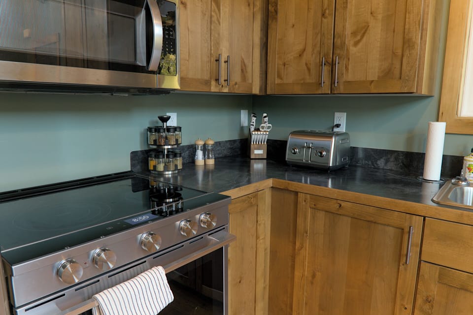 Spices and other cooking supplies are stocked in the kitchen. 