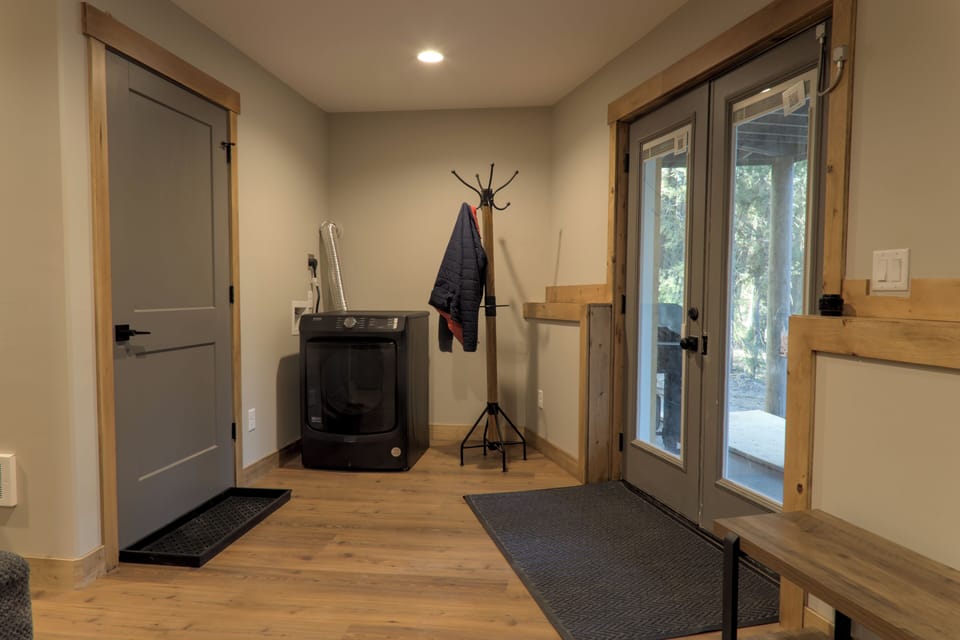 Entry way is through the basement, there is a coat rack and extra dryer. 
