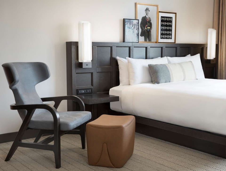 Recharge in a cozy seating corner beside your plush bed.