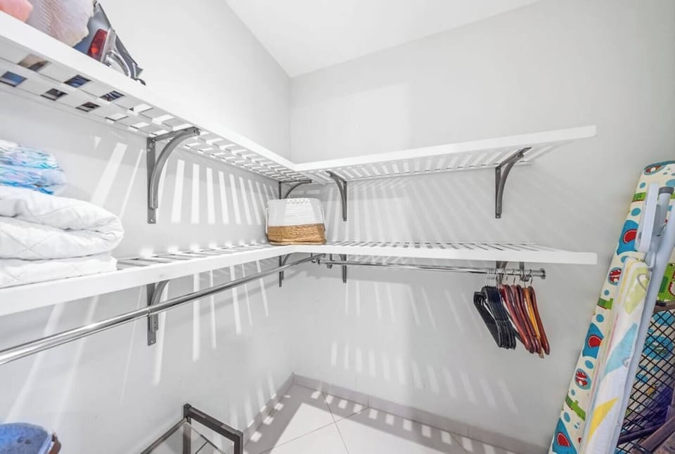 Unwind in Bedroom 2, featuring a queen bed, generous storage closet, and a TV. Whether you're settling in for a quiet night or catching up on entertainment, this room is designed for your ultimate comfort.