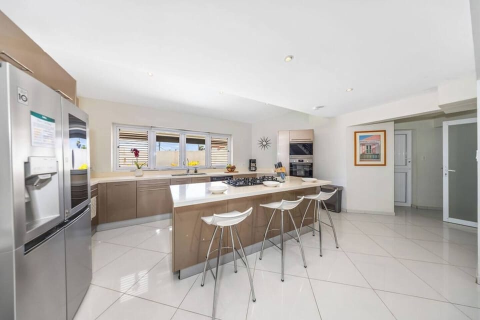Sleek and Modern Kitchen – Cook and entertain in style with a spacious island and bar stool seating for four.
