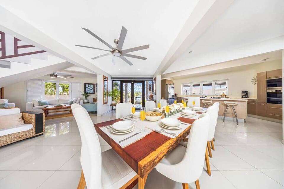 Contemporary Comfort – Enjoy a meal in this beautifully designed dining space, complete with white accent chairs and a chic wooden table.

