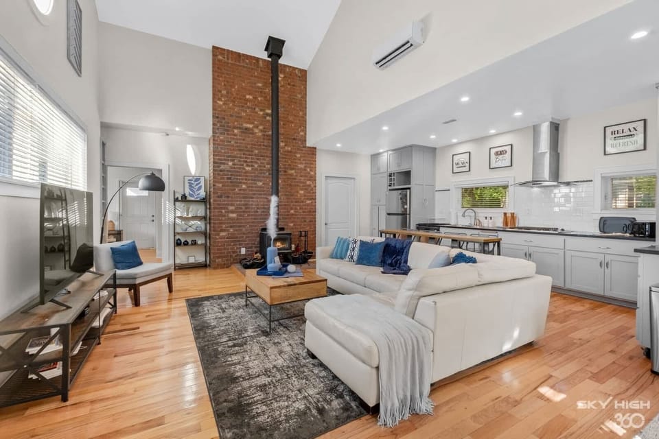 Open concept living room / kitchen with wood-burning fireplace