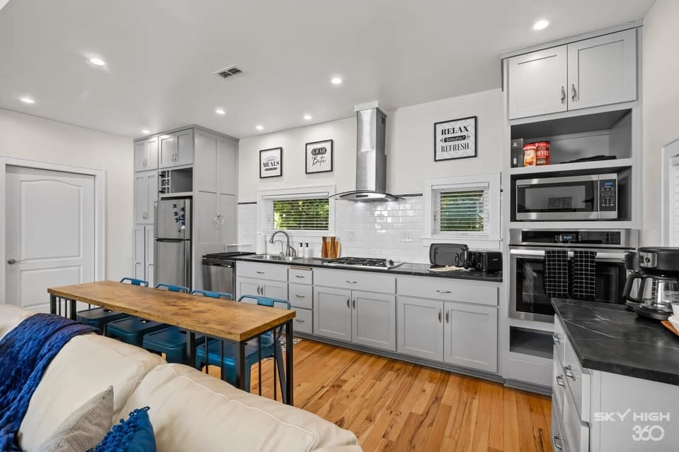 Fully-equipped luxury kitchen with fridge, stove, oven, microwave, coffee maker, dishwasher, pots/pans, silverware, etc...