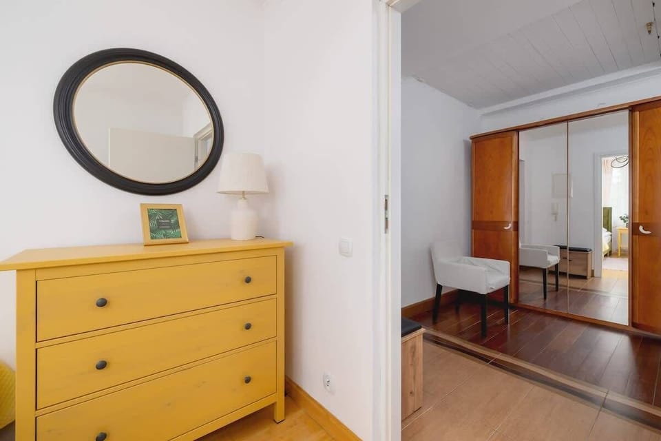 View of the yellow dresser and mirror near the entrance to one of the bedrooms.