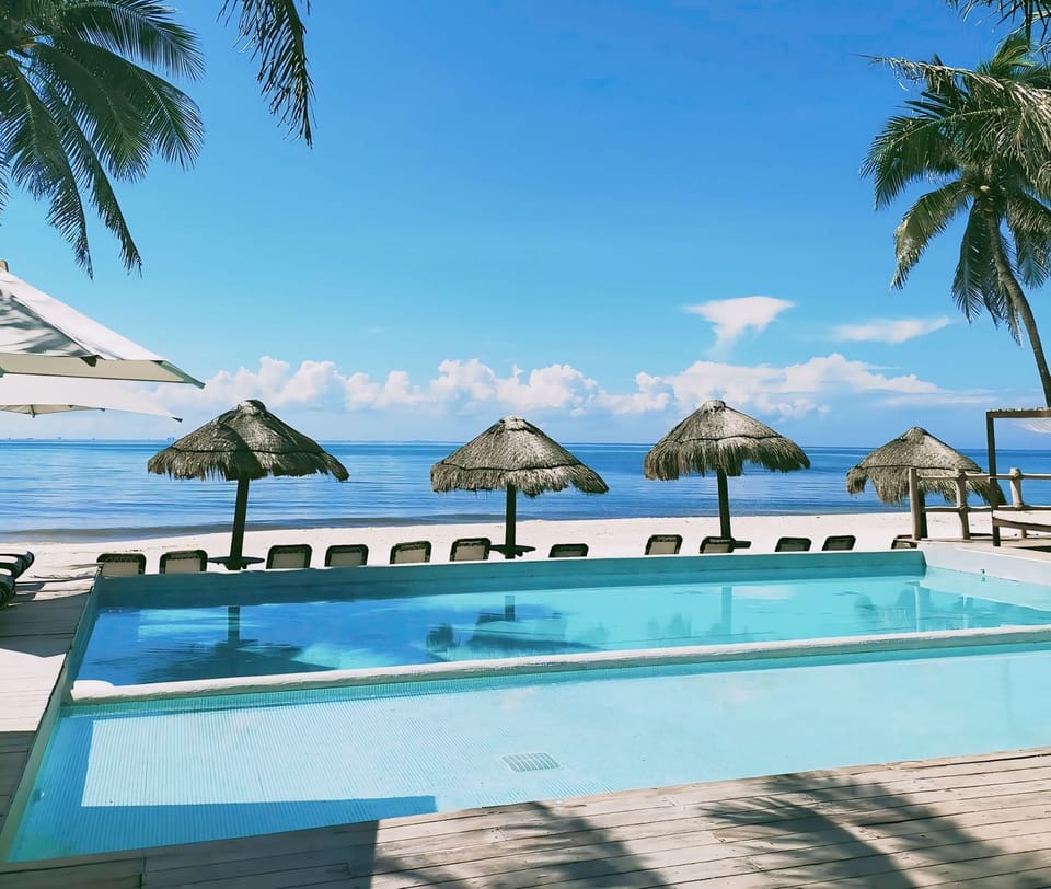 Unwind under the sun on white sands at the Marena Beach Club.