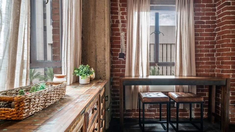 Charming breakfast nook with rustic wooden furniture and plenty of natural light, perfect for a cozy morning coffee.