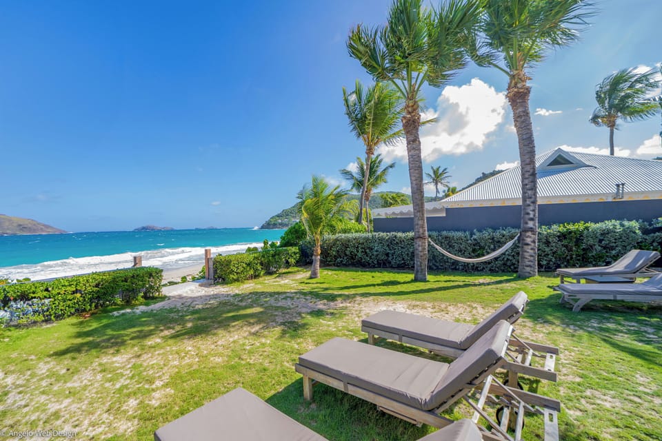 Beachfront property with a direct access on the beach.Nice beachfront garden with tropical flowers, palm trees.  Lounge chairs and hammock under the palm trees. Private parking at the entrance. 