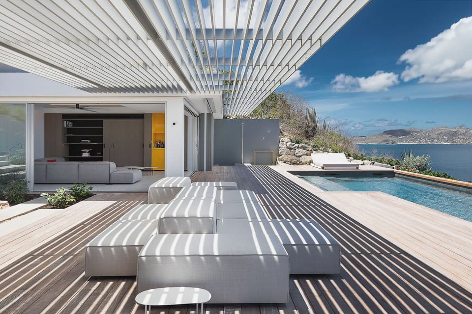 Loungers on the covered terrace facing the panoramic views. 