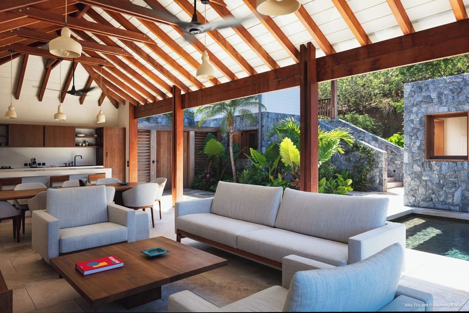 Open-air living room with very comfortable sofas. Ceiling fan, HD-TV, Dish Network, Apple TV. Opens onto the pool and the terrace. 
