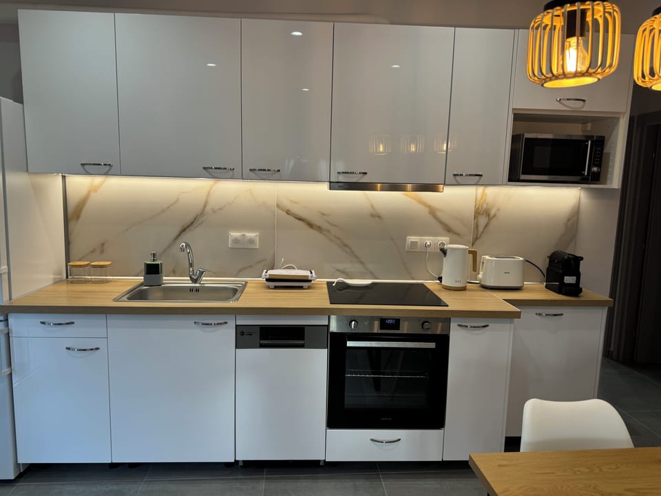 Kitchen with all amenities and dining table.