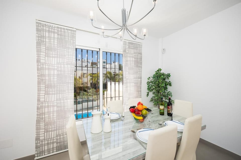 Living room with sofa, dining area, A/C, WiFi internet, and satellite TV