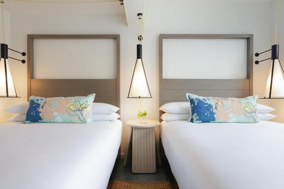 Drift off beneath warm pendant lights and plush pillows.