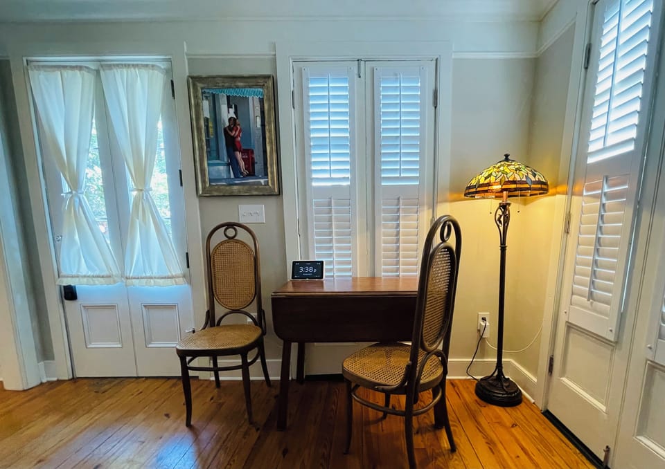 Rectangular drop leaf table with two high back chairs